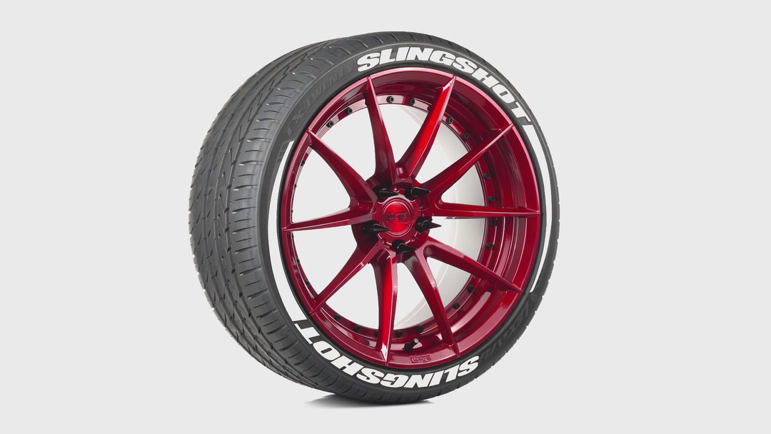 Candy apple red wheel with white tire lettering and black spike lug nuts